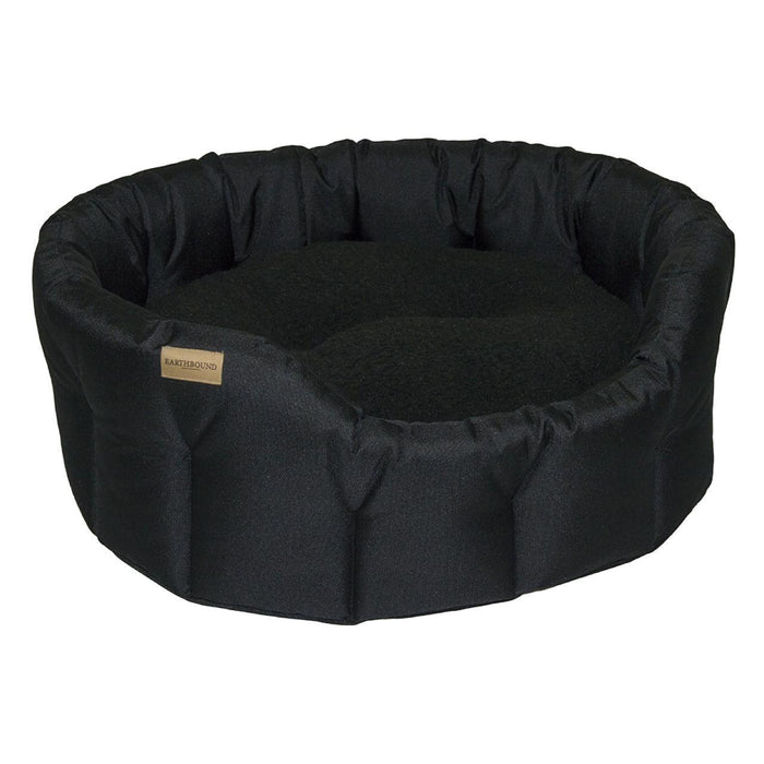 Cama de perros negro redondo clásico clásico de tierra de tierra pequeña